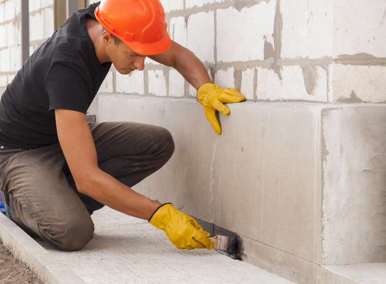 man painting concrete wall